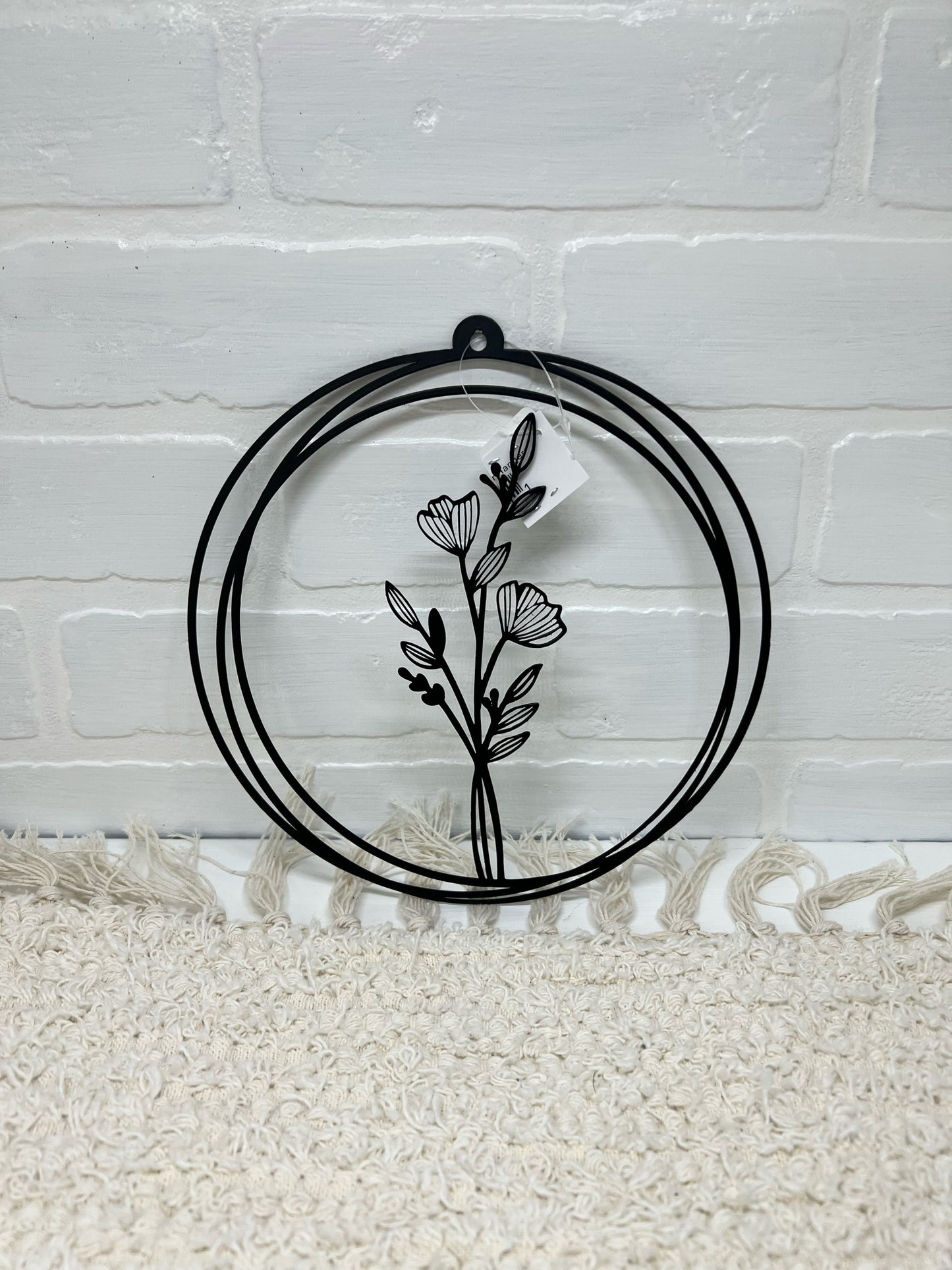 Black metal round floral wall art
